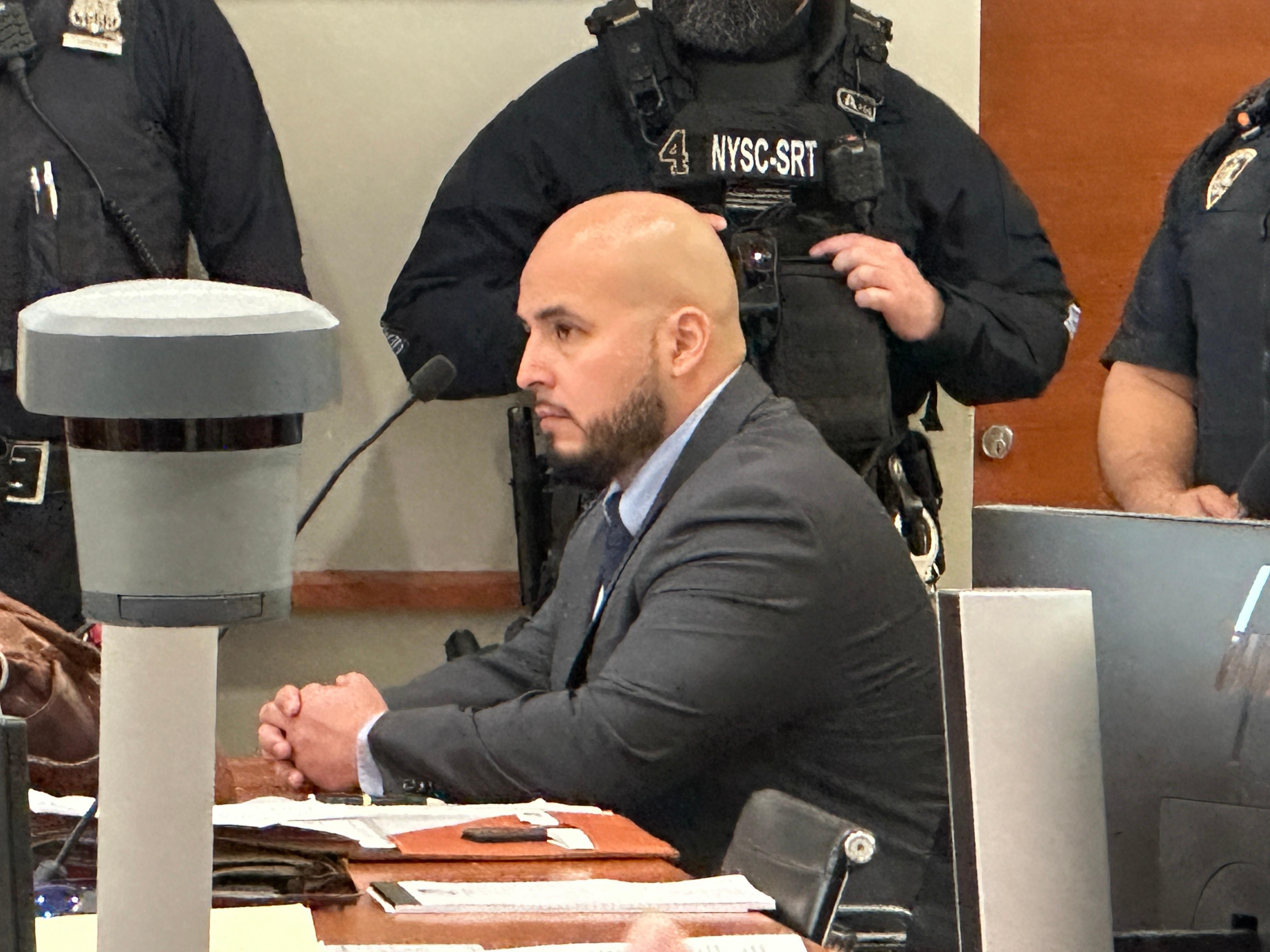 Former New York City police sergeant Erik Duran is seated...