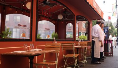 People talk outside an outdoor dining space in New York, Wednesday, July 31, 2024. (AP Photo/Pamela Smith)