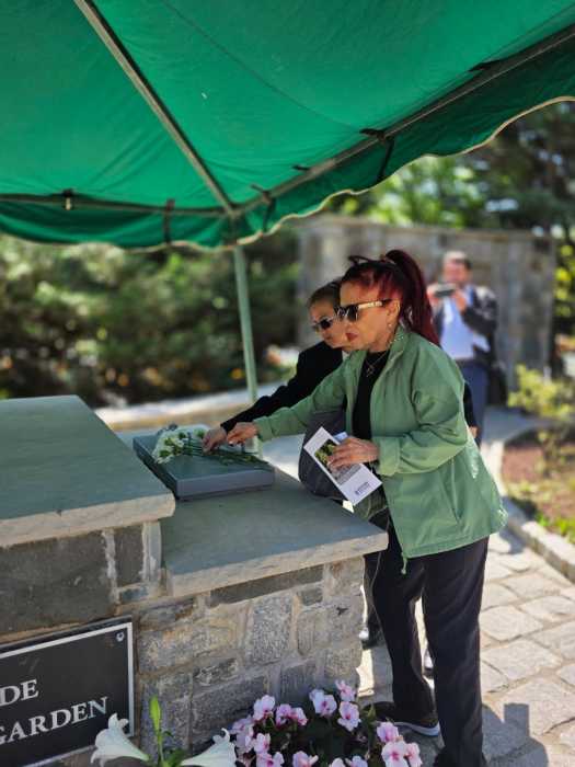 Families lay flowers during Woodlawn Promises Day ceremony.