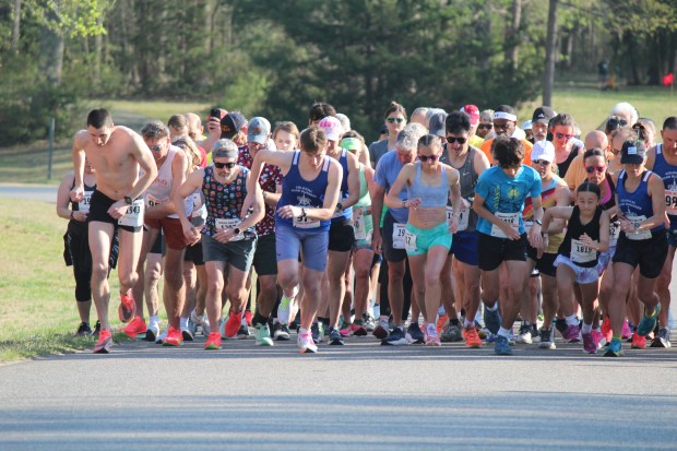 Runners take off at the start of the 32nd annual Queens Lake 5K. Rylan Flint