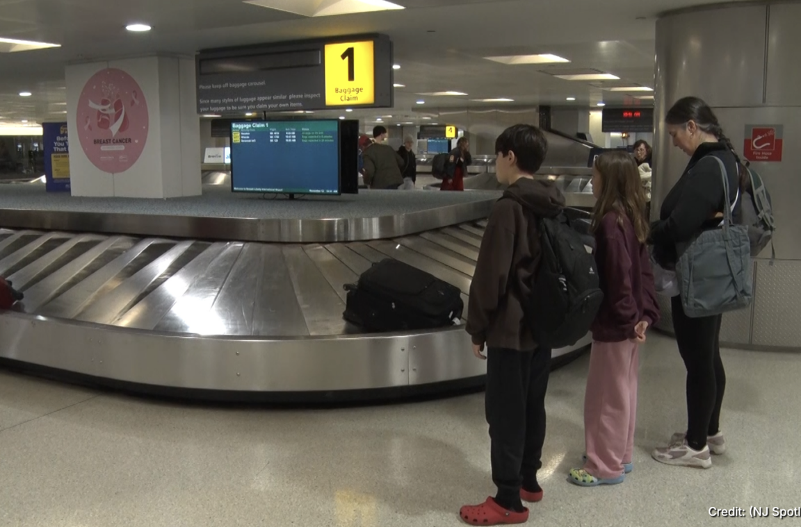 Travelers waiting at baggage claim at Newark Liberty International Airport on Nov. 11, 2025.