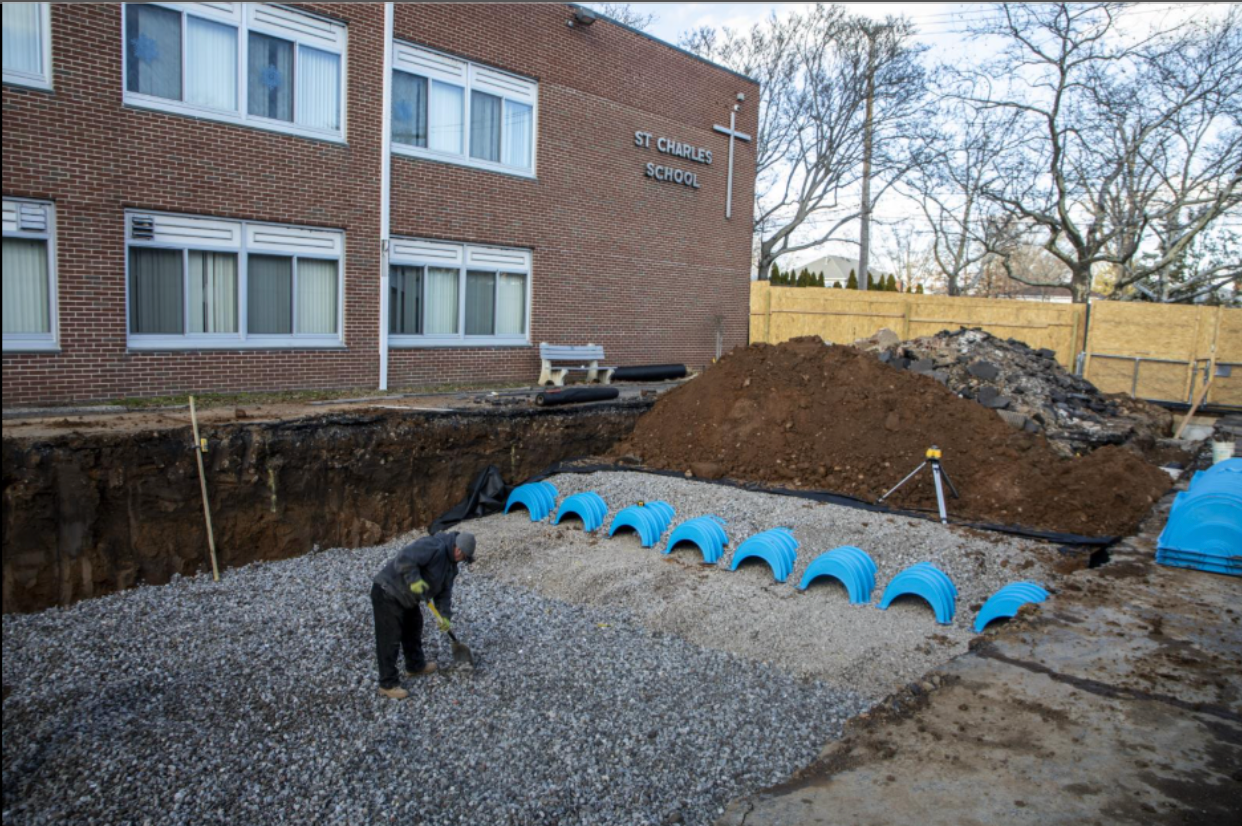 A worker digs as part of a stormwater management project at St. Charles School in the Oakwood section of Staten Island in this undated photo.