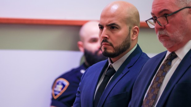 NYPD Sgt. Erik Duran is pictured with his unidentified lawyers during his manslaughter arraignment for causing the August death of a Bronx suspect on a scooter by tossing a cooler at him, causing him to crash. Sargent Duran was being arraigned on a grand jury indictment in the Bronx Hall of Justice Tuesday morning January 23, 2024. The prosecution is being handled by attorneys with state Attorney General Letitia James's office. (Luiz C. Ribeiro for New York Daily News)