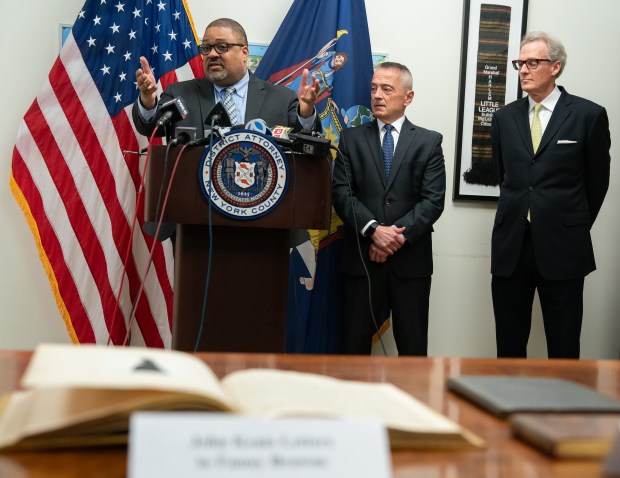 Manhattan District Attorney Alvin Bragg, speaks alongside (L-R) Chief of the Antiquities Trafficking Unit, Senior Trial Counsel Matthew Bogdanos and Peter di Bonaventura at a press conference announcing the return of 17 rare books to the family of John Hay Whitney Monday, April 20, 2026 in Manhattan, New York. (Barry Williams/ New York Daily News/)