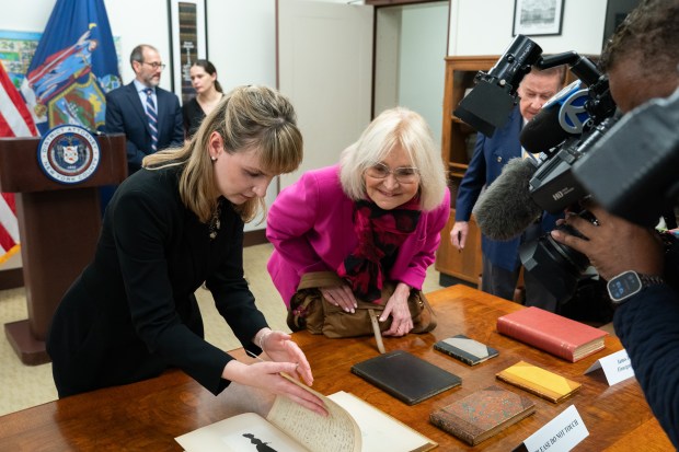 Manhattan DA antiquities trafficking analyst Hilary Chasse gently turns a page from a bound collection of 37 love letters written by the British Romantic poet John Keats to his fiancée Fanny Brawne after a press conference announcing the return of 17 rare books to the family of John Hay Whitney Monday, April 20, 2026 in Manhattan, New York. (Barry Williams/ New York Daily News/)