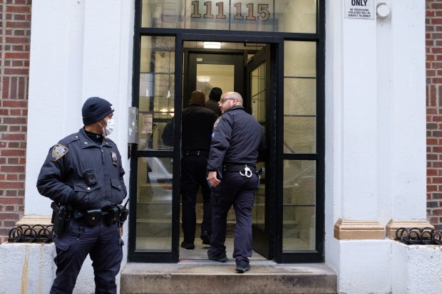 Police investigate after Basilisa Negron was found shot to death inside 115 W. 141 St. in Manhattan, New York on Tuesday, December 23, 2025. (Gardiner Anderson / New York Daily News)