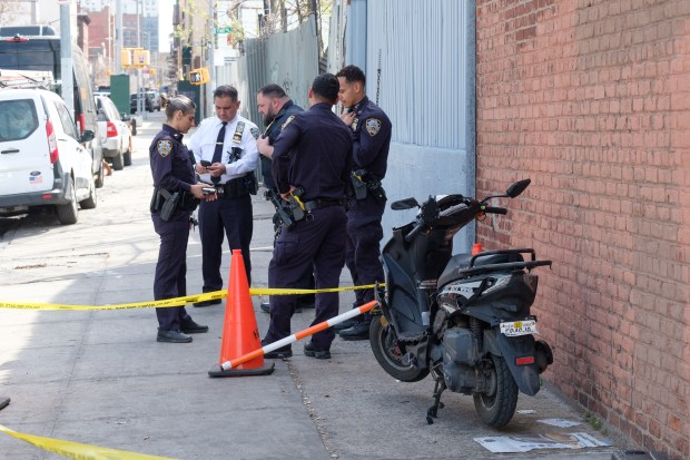 Police secure the scene of an abandoned scooter on Warsoff Place near Park Ave. in Brooklyn, New York on Wednesday, April 1, 2026, after a child was shot approximately one mile away on Humboldt St. and Moore St. (Gardiner Anderson / New York Daily News)