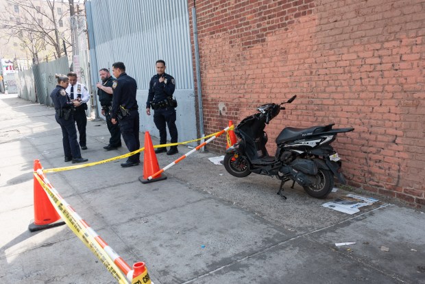 Police secure the scene of an abandoned scooter on Warsoff Place near Park Ave. in Brooklyn, New York on Wednesday, April 1, 2026, after a baby was shot nearby on Humboldt St. and Moore St. 