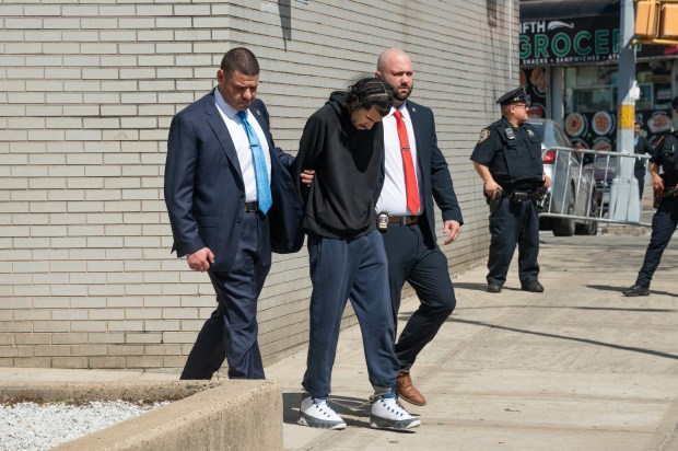 Matthew Rodriguez is pictured in police custody outside the NYPD's 90th Precinct stationhouse in Williamsburg, Brooklyn, on Tuesday, April 14, 2026, after being charged in the death of Kaori Patterson-Moore. (Gardiner Anderson / New York Daily News)
