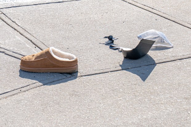 A shoe is seen on the street after a moped crash on Hinsdale St. and Pitkin Ave. in Brownsville, Brooklyn on Saturday. 