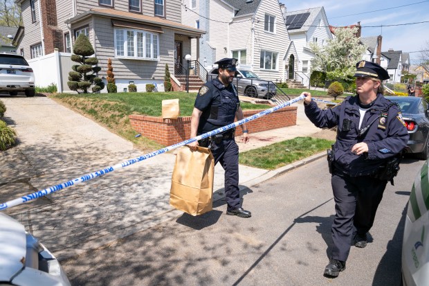 Police investigate after a man, allegedly enraged over a dog peeing on his lawn, stabbed multiple people on 229th St. near 141st Ave. in Queens on Thursday, April 23, 2026. (Theodore Parisienne / New York Daily News)