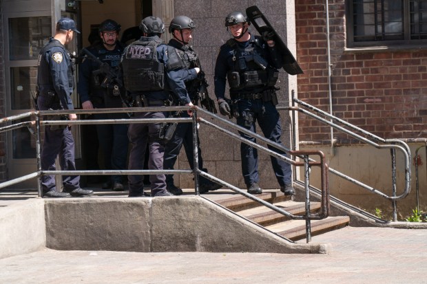 Police at the scene where authorities said a 43-year-old man was shot and killed by his 16-year-old stepson in an apartment building in Brooklyn. 