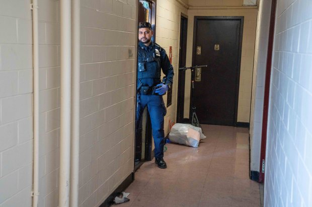 Police are pictured at the scene where a 43-year-old man was allegedly shot and killed by his 16-year-old stepson in an apartment building on Cumberland Walk in Brooklyn on Sunday April 12, 2026. (Theodore Parisienne / New York Daily News)