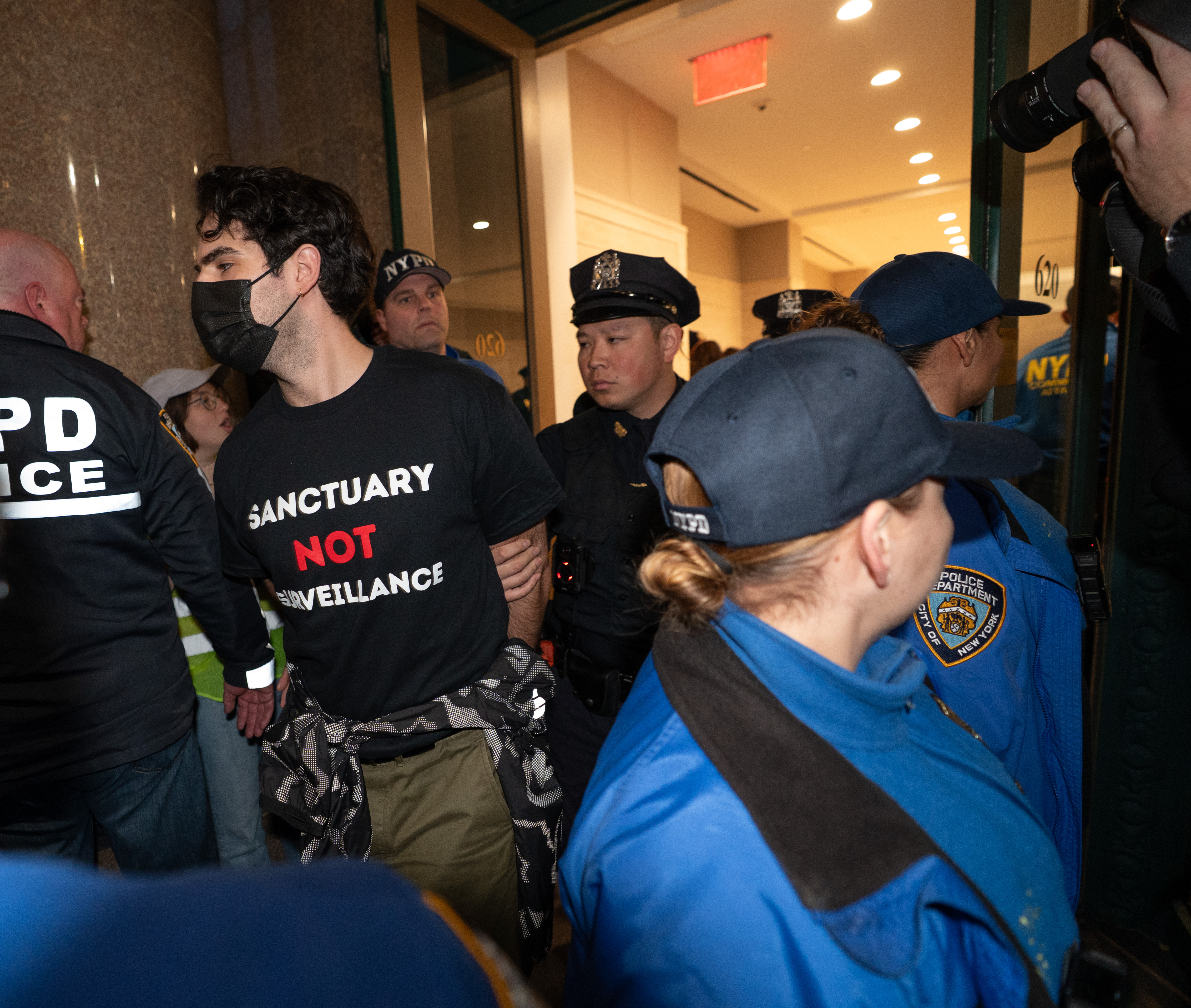 Protestors are led to NYPD vans after being arrested for...
