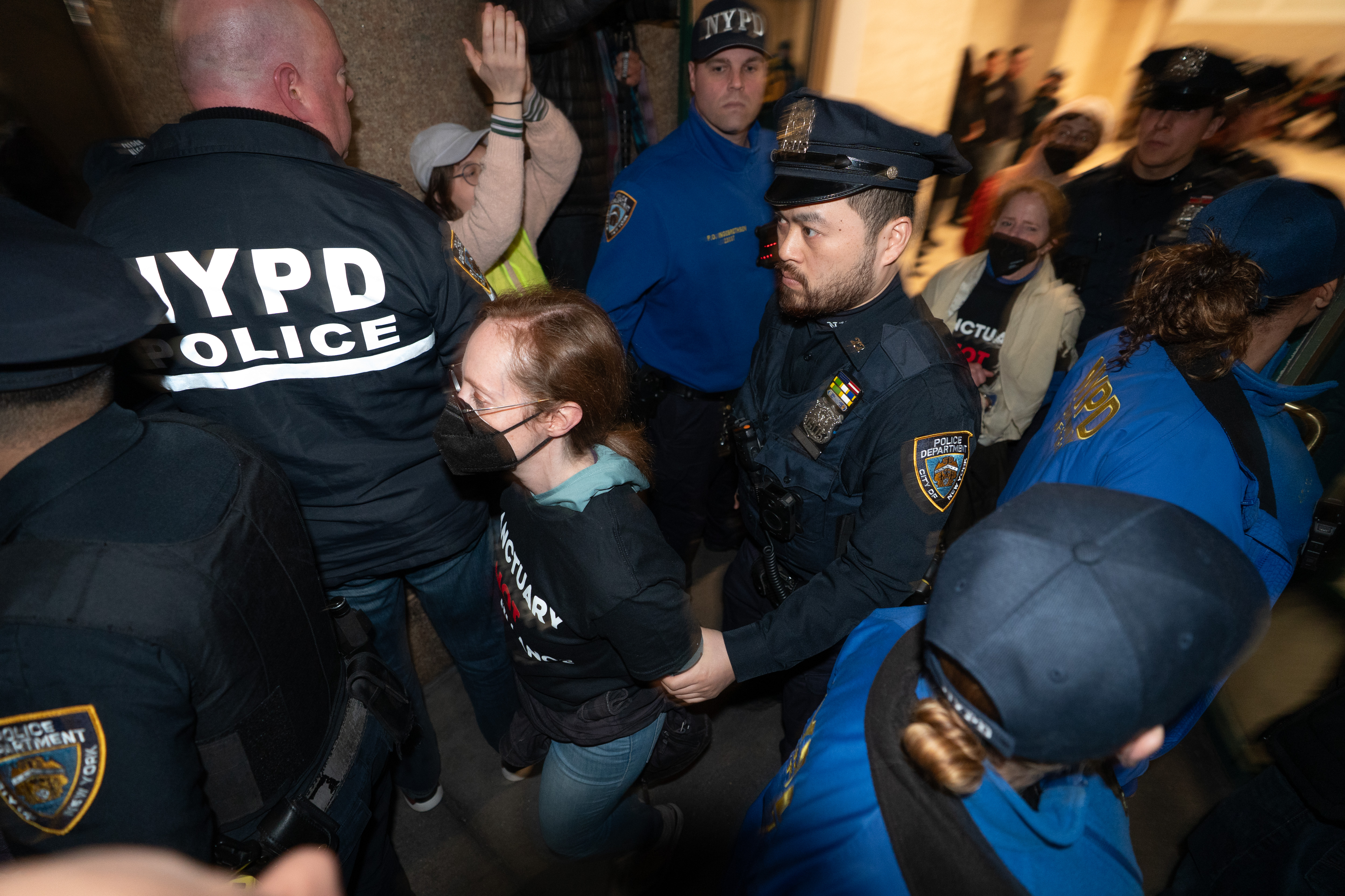 Protestors are led to NYPD vans after being arrested for...