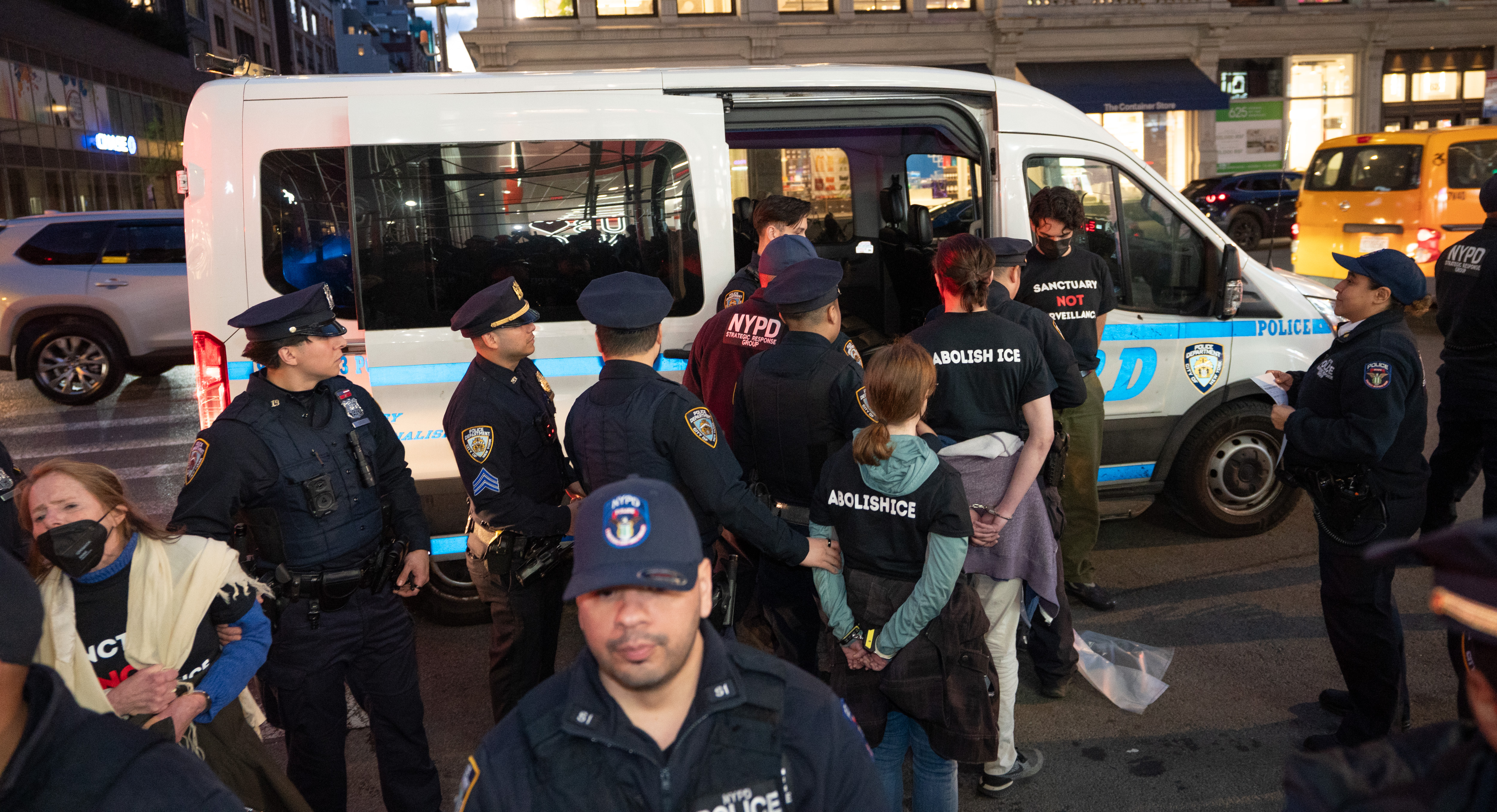 Protestors are led to NYPD vans after being arrested for...