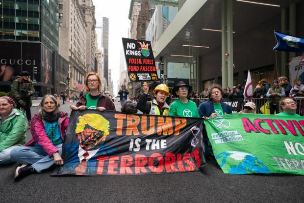 Climate activists from Extinction Rebellion protest outside Trump Tower by blocking Fifth Ave. in Manhattan on Wednesday, April 22, 2026. (Barry Williams/ New York Daily News)