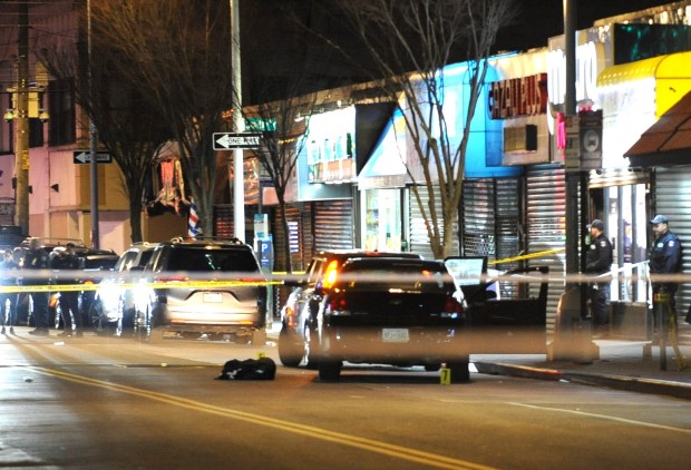 Police secure a vehicle in front of 1919 Mott Ave. in Far Rockaway, Queens, after NYPD Officer Jonathan Diller was fatally shot while making a car stop on Monday, March 25, 2024. (Sam Costanza for New York Daily News)