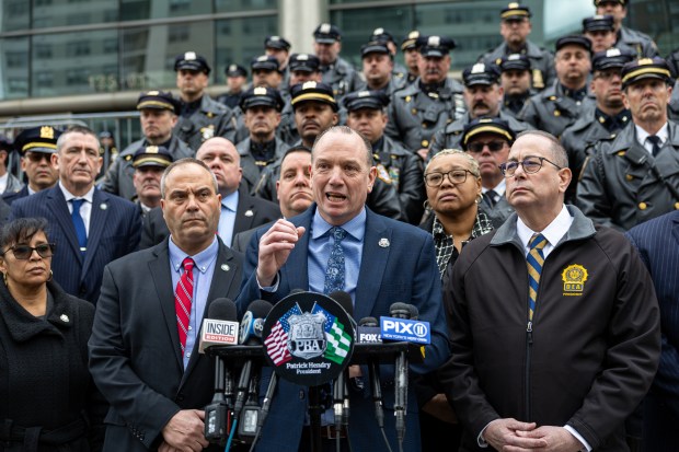 President of the Police Benevolent Association Patrick Henry, center, speaks during a press conference outside Queens Criminal Court in Queens, New York on Wednesday, Feb. 21, 2024. (Shawn Inglima for New York Daily News)