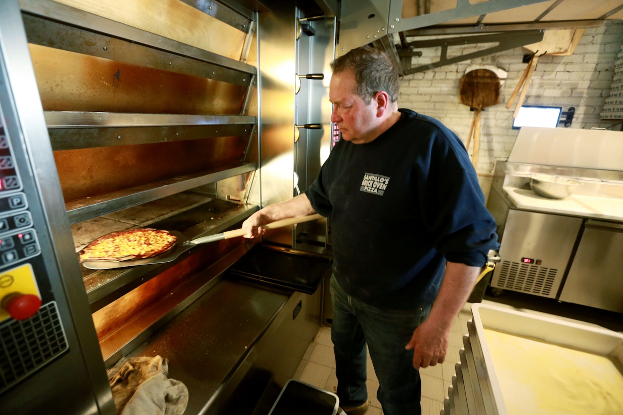 Pizza maker Al Santillo is making pizza at Coniglio’s as his place is being rebuilt