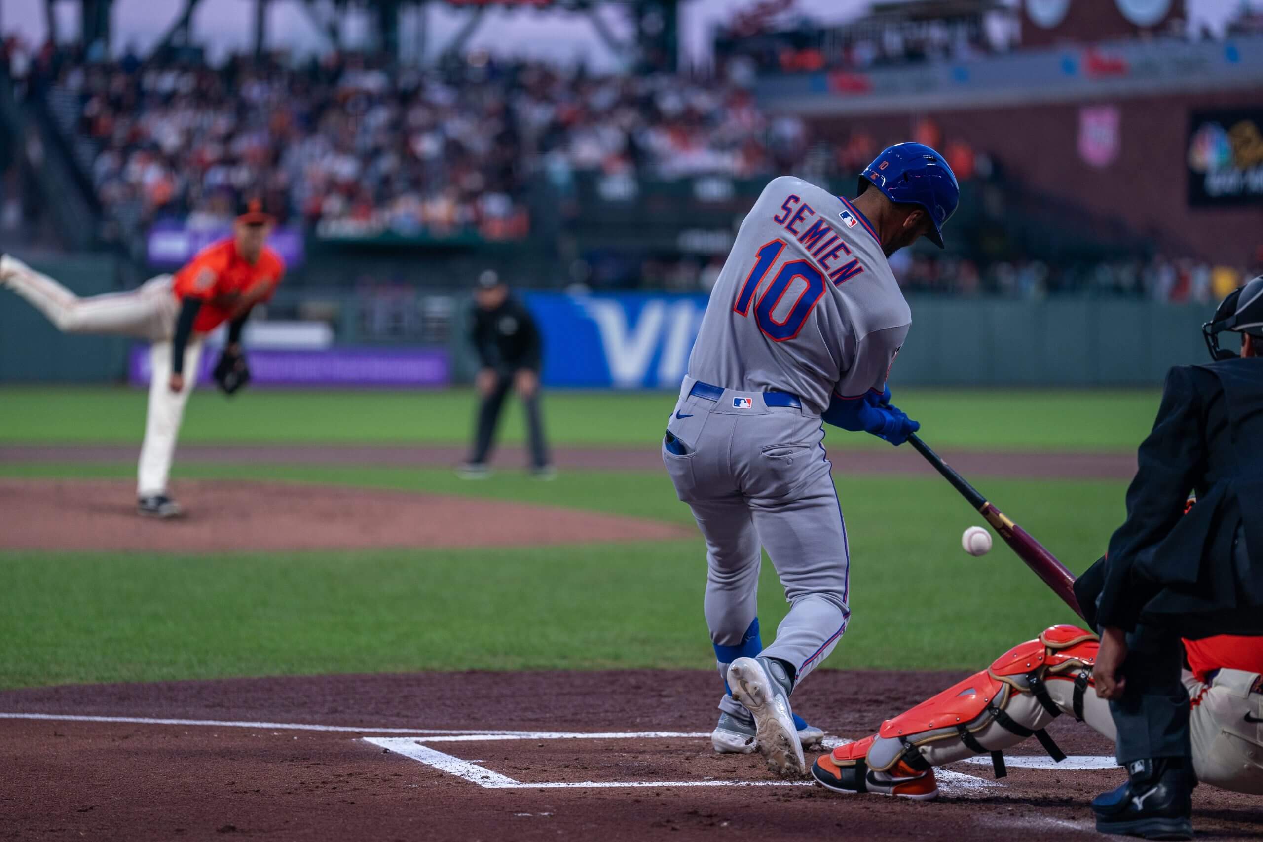 Mets second baseman Marcus Semien (No. 10) swings at a pitch.