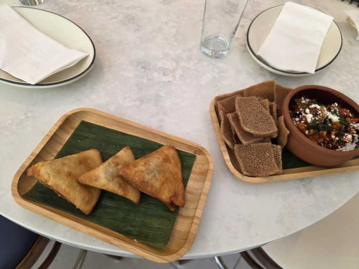 Sambusas (left) and injera bruschetta at Makina. Photo by Shane O'Brien.