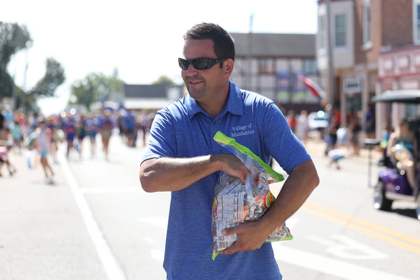 Village of Manhattan Mayor Mike Andrieansen hands out candy to the crowds in the Labor Day Parade on Monday, Sept. 4, 2023 in Manhattan.