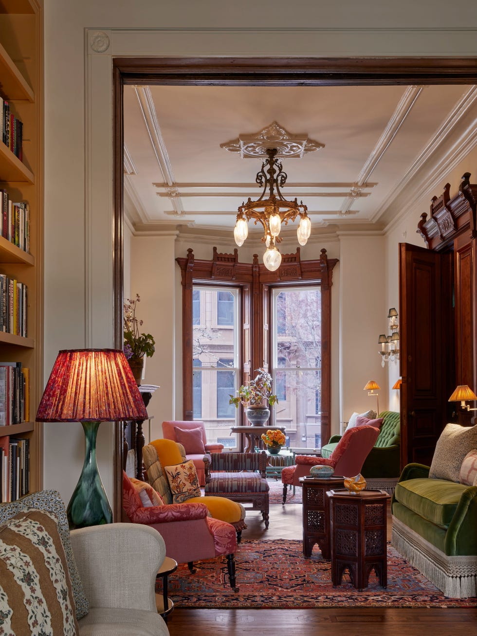 Cozy living room with colorful furniture and a chandelier.