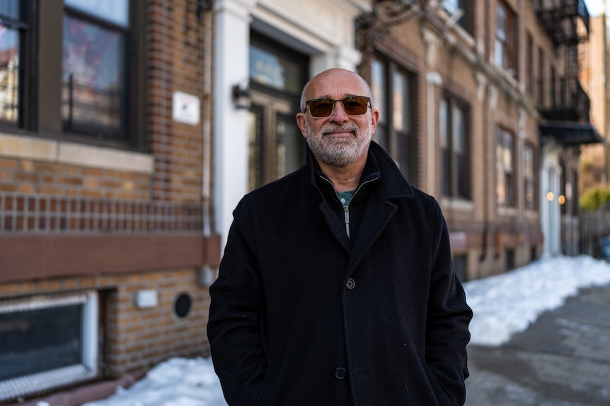 A man in front of a building.