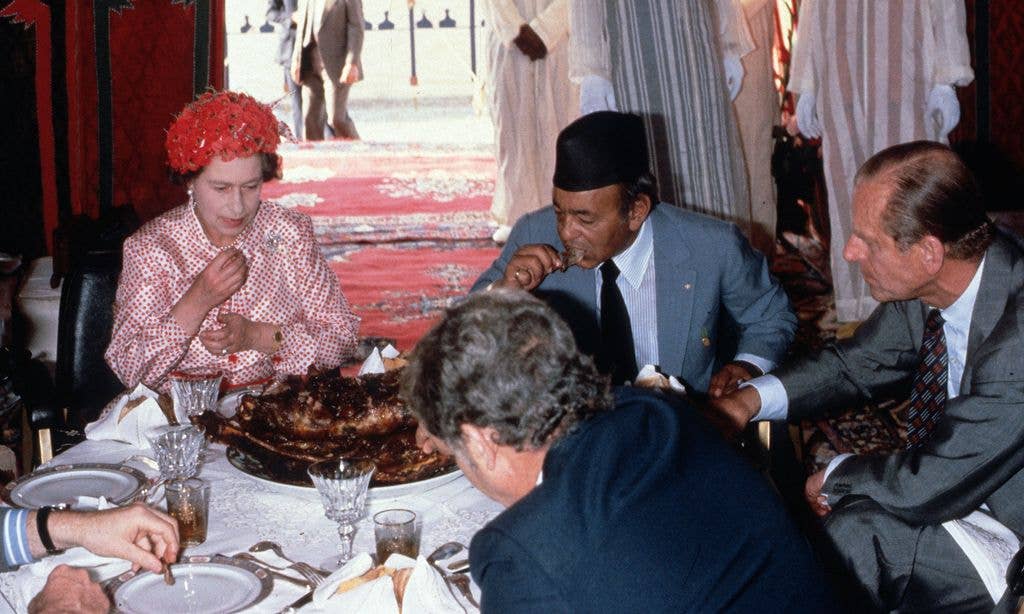 Queen Elizabeth II, Prince Philip, Duke Of Edinburgh And King Hassan Ll Eat With Their Hands As They Attend A Feast In The Desert On October 27, 1980 In Morocco