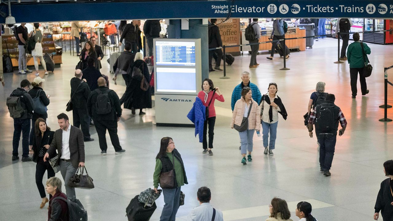 Evening rush hour commuters make their way through the Penn Station concours, Thursday, May 2, 2019 in New York. The increasing challenges posed by the New York area's aging rail infrastructure came into sharp focus Thursday as a congressional delegation prepared to get a firsthand look at the country's busiest station on the same day commuters learned about summer schedule disruptions due to track repairs. (AP Photo/Mary Altaffer)
