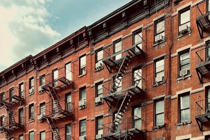 Brick apartment building with fire escapes