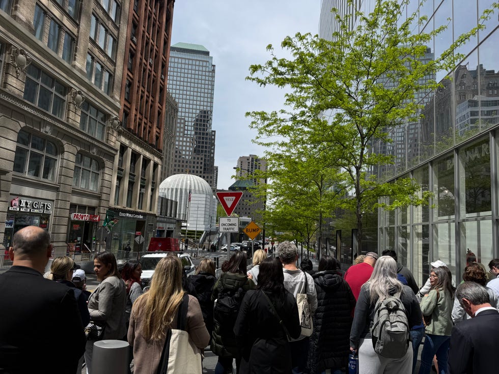 Crowd gathered on a city street near modern buildings