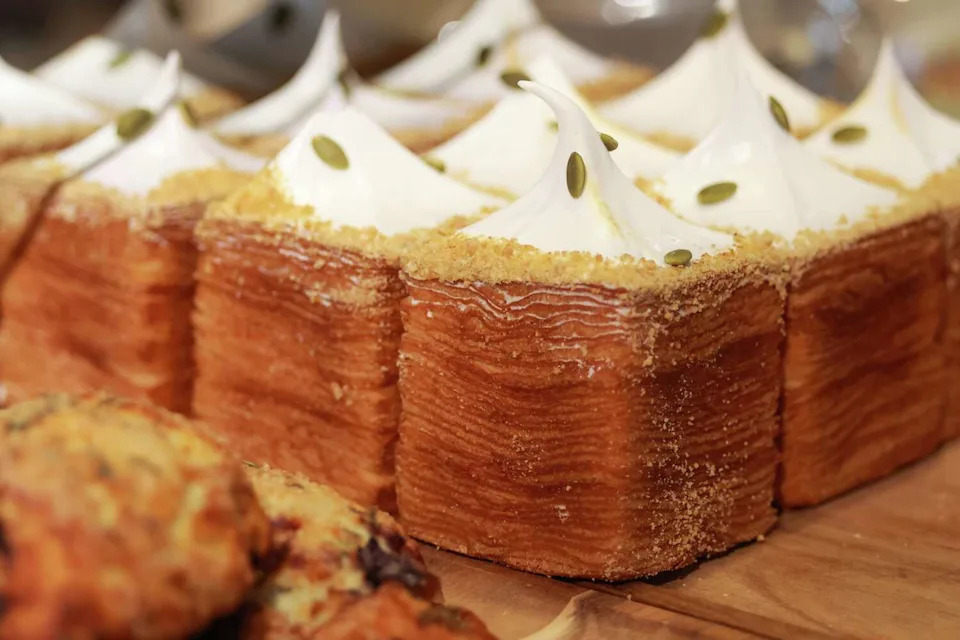 The Pumpkin Pie Croissant Cube was a late 2025 offering at Maman. Now that it's spring 2026, the croissant cube is cherry flavored and topped with with torched meringue. (Christine Vo/Staff Photographer)