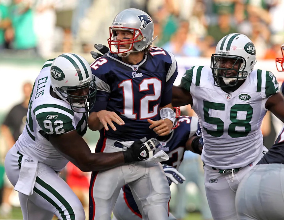 New York Jets defensive end Shaun Ellis (92) and New York Jets linebacker Bryan Thomas (58) put pressure on New England Patriots quarterback Tom Brady.