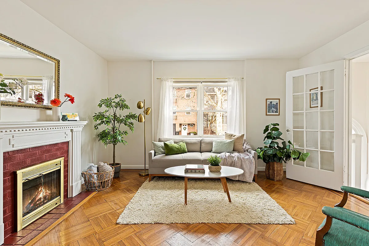 living room with a mantel and wood floor