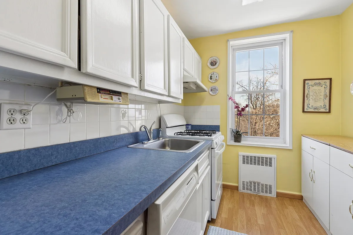 kitchen with blue formica, white cabinets