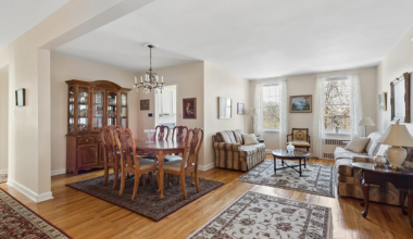 a living room with a wood floor, beige walls