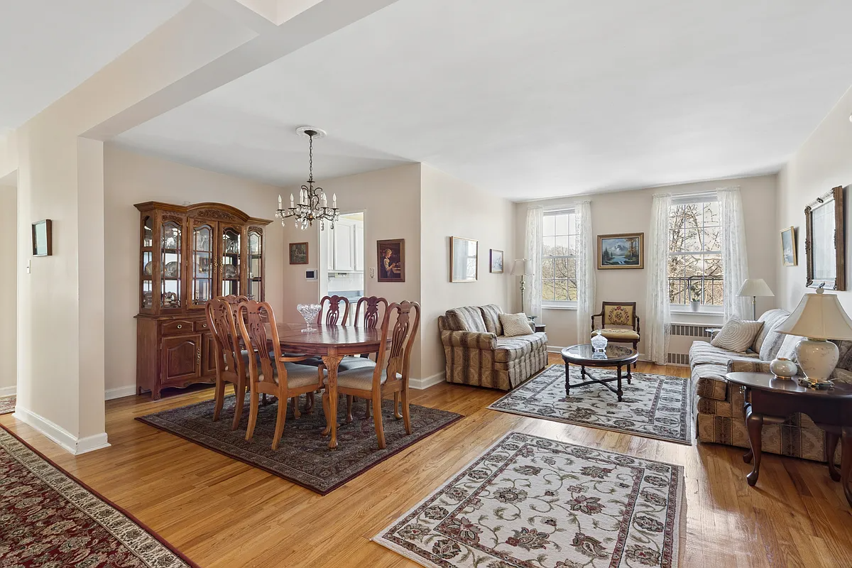 a living room with a wood floor, beige walls