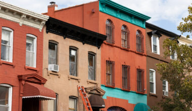 ladder leaning against a brownstone
