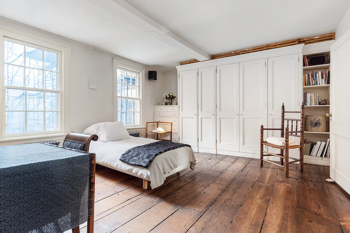 bedroom with built-in storage, wood floor