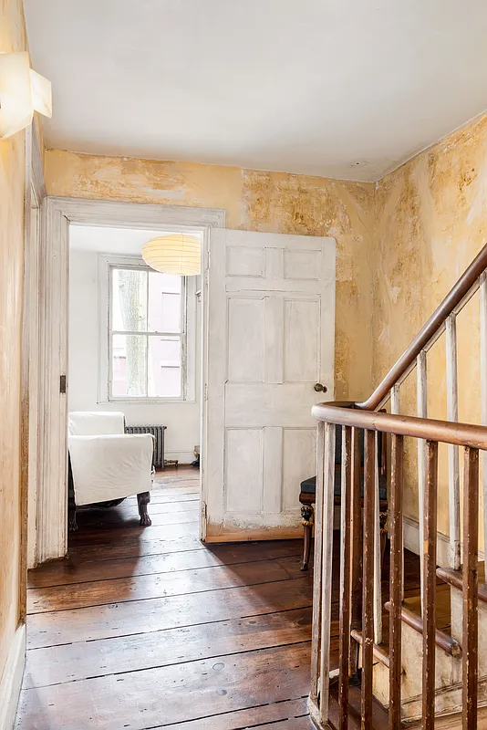 upstairs hall with wide planked floorboards