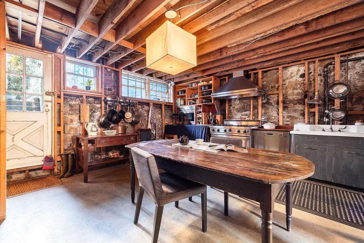 kitchen with exposed rafters, pipes, vintage sink cabinet