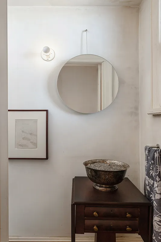 detail of a bathroom with an oval mirror