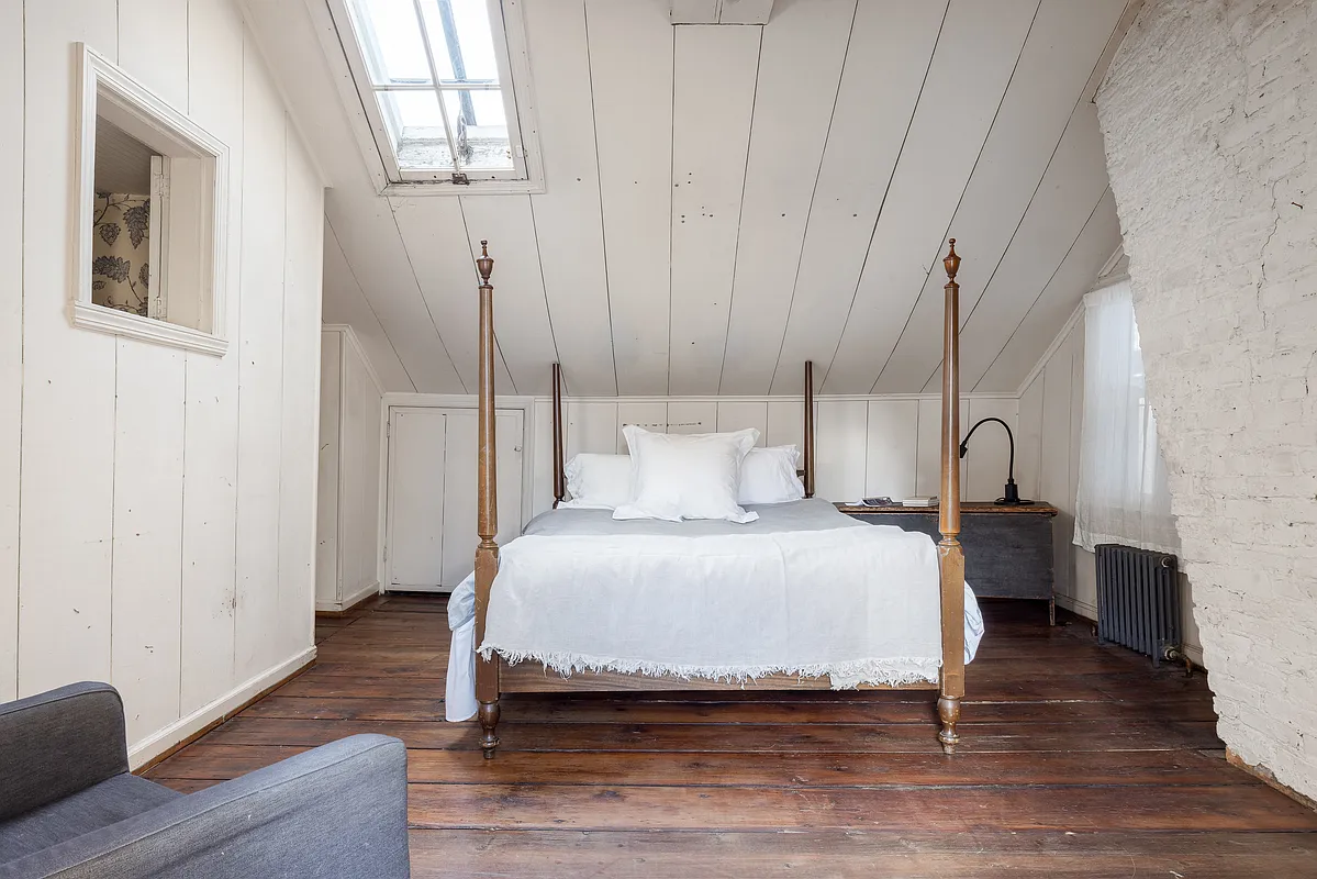 bedroom with white painted panelling, skylight