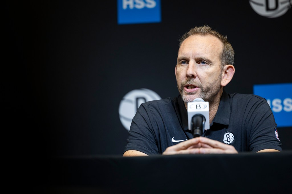 Brooklyn Nets GM Sean Marks speaks into a microphone.
