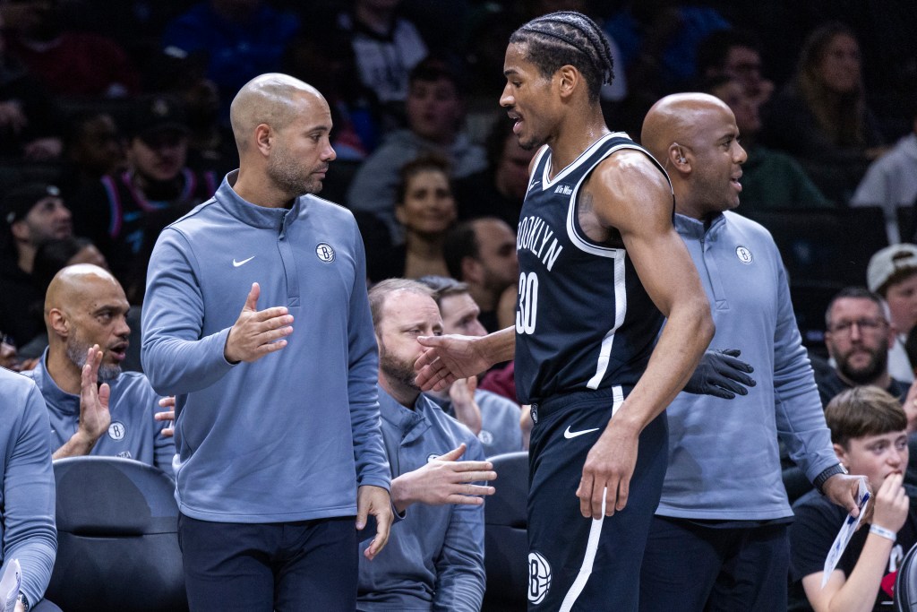 Brooklyn Nets head coach Jordi Fernandez greets Brooklyn Nets guard Ochai Agbaji (30) during the second half at Barclays Center, Sunday, April 5, 2026, in Brooklyn, NY. 