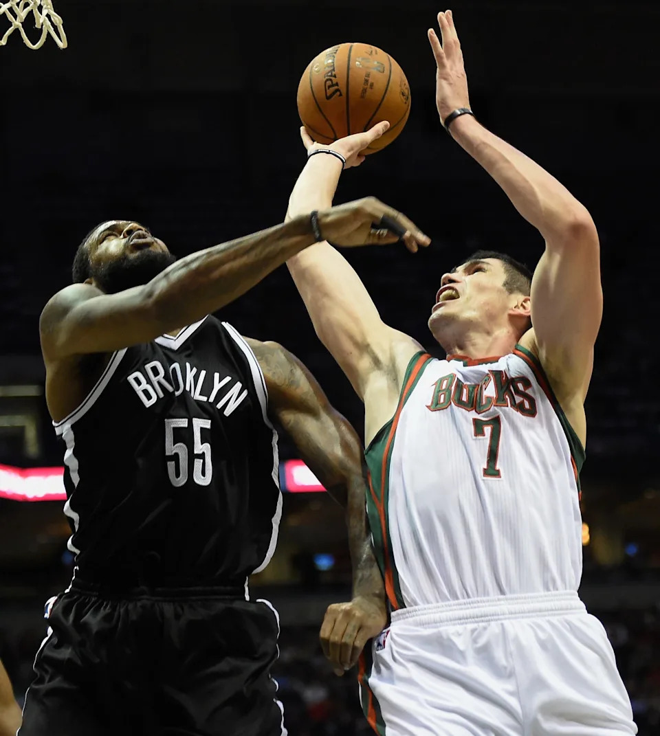 Apr 12, 2015; Milwaukee, WI, USA; Milwaukee Bucks forward Ersan Ilyasova (7) shoots the ball as Brooklyn Nets forward Earl Clark (55) defends in the third quarter at BMO Harris Bradley Center. The Bucks won 96-73. Mandatory Credit: Benny Sieu-USA TODAY Sports