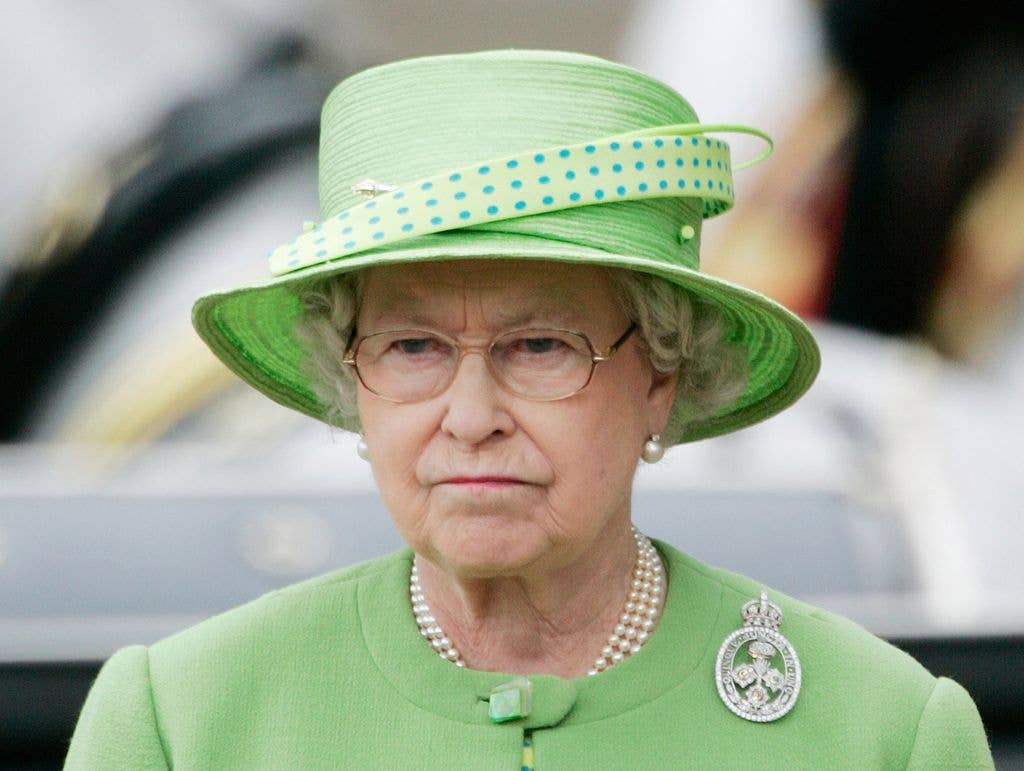 The Queen frowning in a matching green co-ord