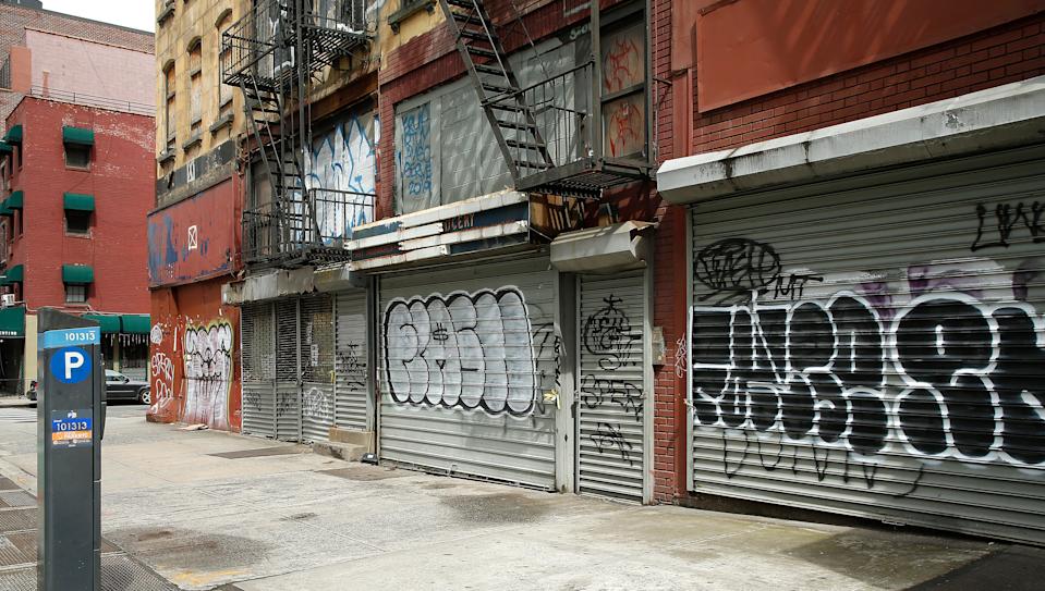 Small businesses in New York City with their security gates rolled down.